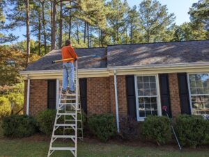 A man climbing a ladder to work on a roof